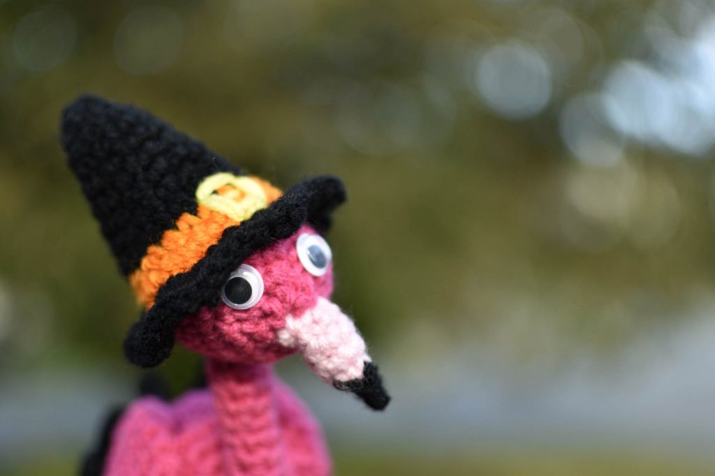 crochet flamingo wearing a witch's hat