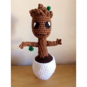 crochet baby groot doll standing on a table