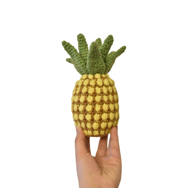 crochet pineapple against a white background
