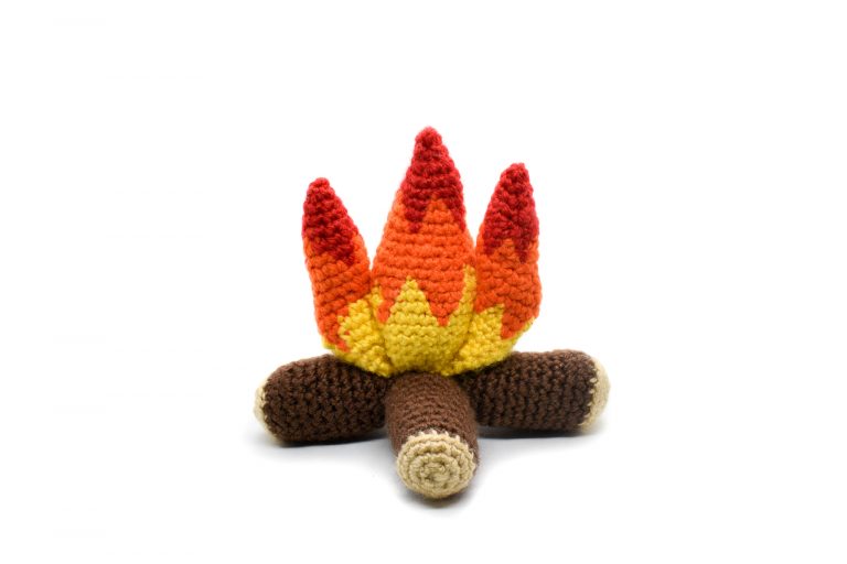 a small plush crochet campfire against a white background