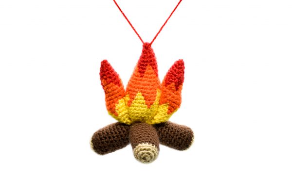 a small plush crochet campfire against a white background