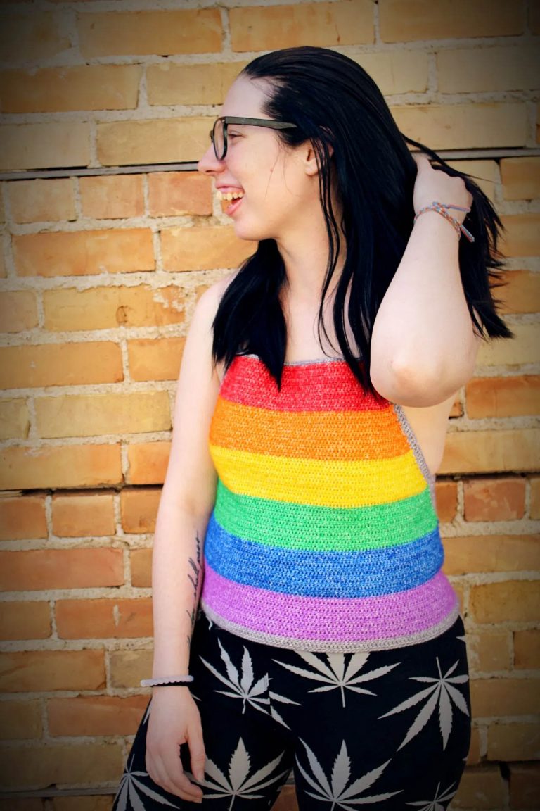 a woman wearing a rainbow striped crochet crop top