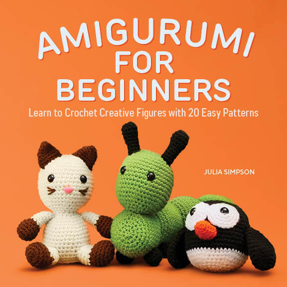 An orange book cover with the title "Amigurumi for Beginners: Learn to Crochet Creative Figures with 20 Easy Patterns" by Julia Simpson. The cover includes photos of 3 stuffed crochet dolls: a white and brown cat, a big green caterpillar, and a small ball-shaped penguin.