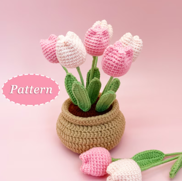 a light brown crochet flower pot with crocheted pink tulips in it